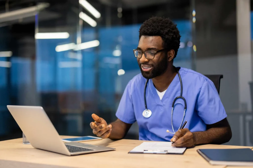 Healthcare professional taking notes at a desk during an online career workshop through Workforce Solutions Capital Area
