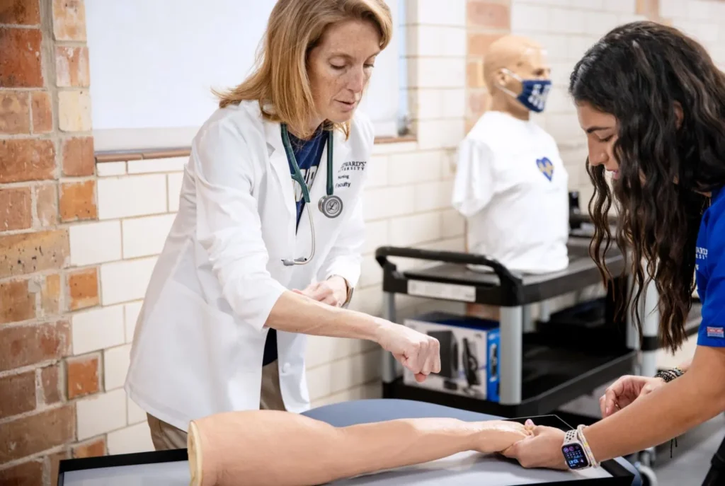 Two women working on a prosthetic arm in a clinical setting representing Clinical Placement services at Workforce Solutions partnered with Central Texas Healthcare.